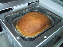 A bread machine with freshly baked bread