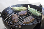 Food cooking on a charcoal grill