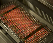 An ignited Infrared grill burner, only seeing the visible light spectrum.