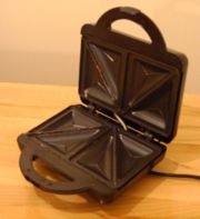 A photo of an opened Bifinett sandwich toaster.