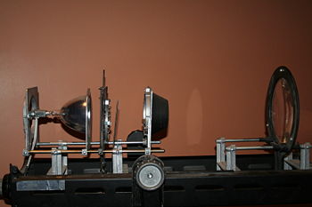 Optics of a Altman 1000Q followspot.  From left to right: Lamp, Ellipsoidal Reflector, Shutter/Iris Assembly, Fixed Lens, Variable Lens.