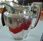 19th Century Tiffany & Co. Pitcher. Circa 1871. Pitcher has paneled sides, and repousse design with shells, scrolls and flowers. Top edge is repousse arrowhead leaf design