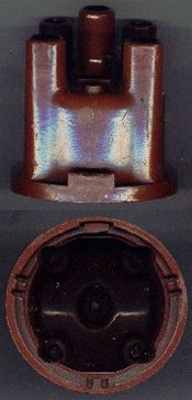 Distributor cap. At the center is a spring loaded carbon button that bears upon the rotor. The number of distribution points (in this case 4) is determined by the number of cylinders in the engine