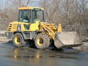 A front loader with articulated steering.