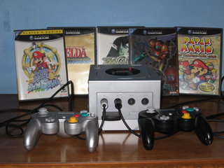 A Platinum Nintendo GameCube with two controllers, a memory card, and five games (Super Mario Sunshine, The Legend of Zelda: The Wind Waker, Soul Calibur II, Metroid Prime 2: Echoes, Paper Mario: The Thousand-Year Door).